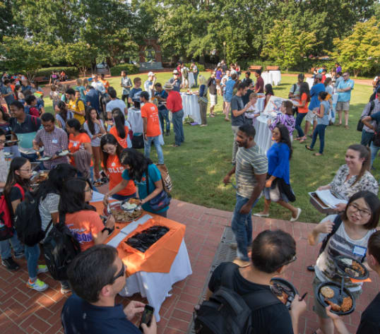 International students congregate in the Carillon Garden for a first-week event.