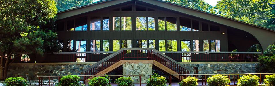 Trees are reflected in the windows that line the conference building at the Clemson University Outdoor Lab.